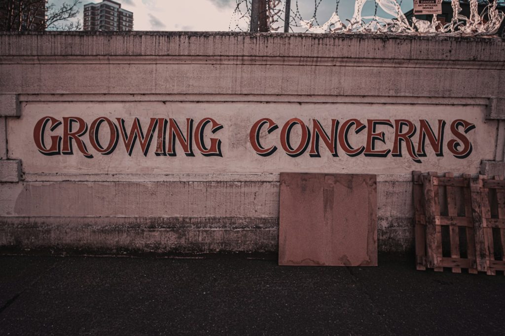 a sign on the side of a building that says growing concerns