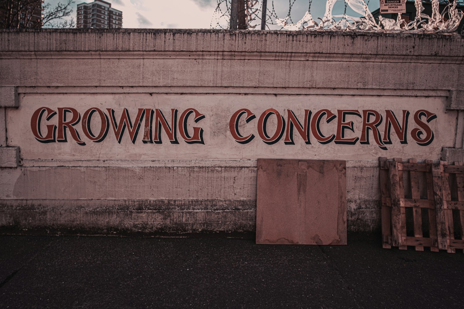 a sign on the side of a building that says growing concerns